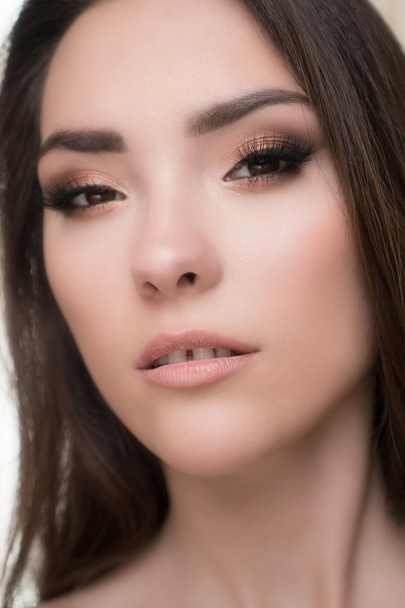 Closeup of beautiful brunette woman with pretty eyes and gap between teeth  - Fotografie, Obrázek