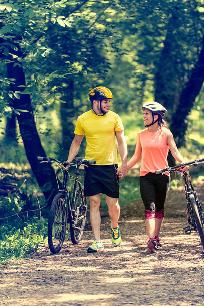couple holding hands with bicycles - Photo, Image
