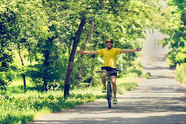 cheerful man riding bicycle - Photo, Image