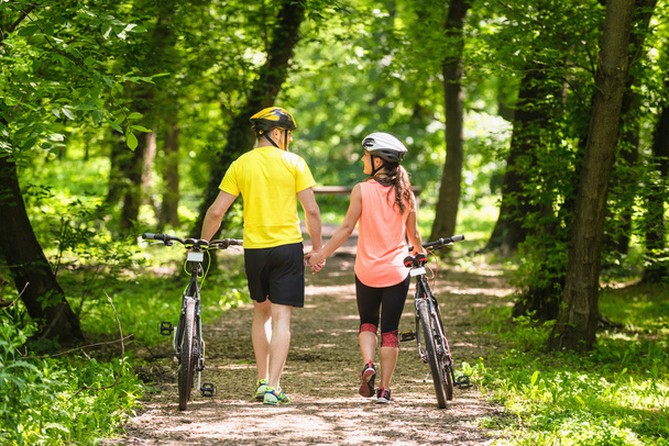 Couple walking with bicycles - Photo, Image