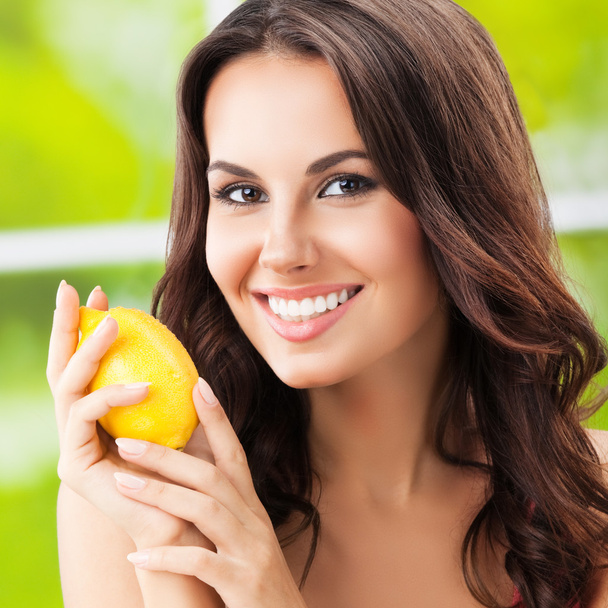 happy smiling woman with lemon, outdoors - Photo, Image