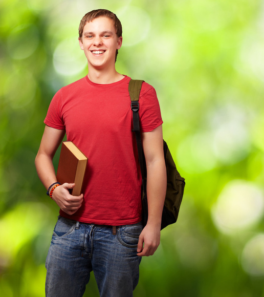 Retrato de jovem estudante segurando livro e carregando mochila aga
 - Foto, Imagem