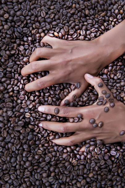 Hands of a young woman and coffee beans - Photo, Image