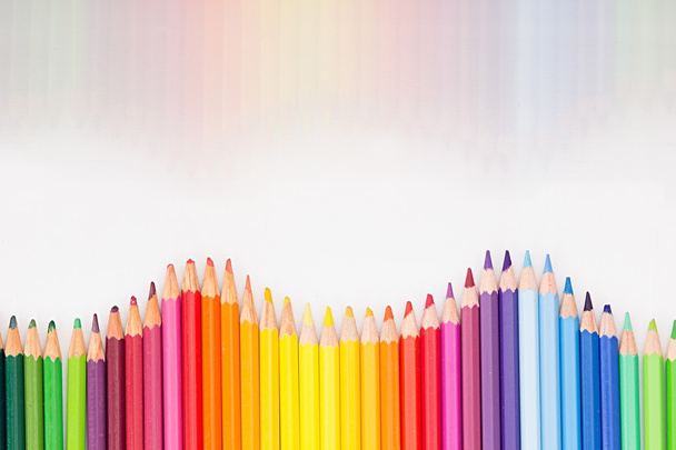 Colored pencils in rainbow order on white background. Pencils background. - 写真・画像