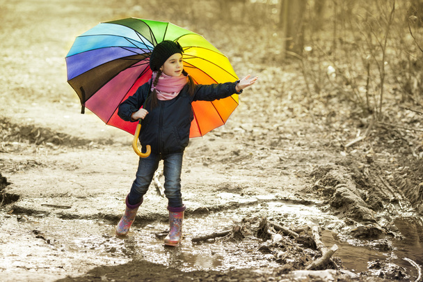 Girl with multicolored umbrella in autumn park - Photo, Image