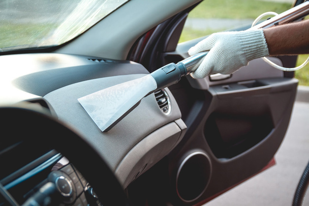 Vacuum cleaning the dashboard - 写真・画像
