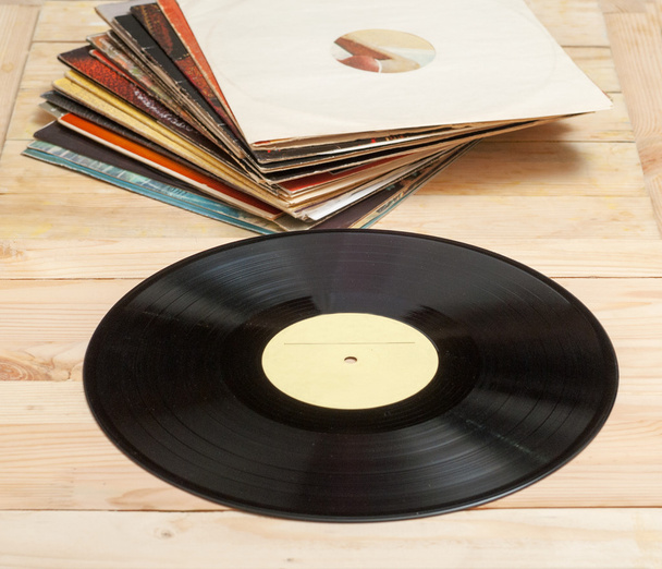 Vinyl record with copy space in front of a collection albums dummy titles, vintage process - Foto, Bild