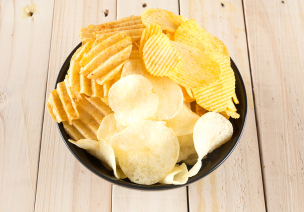 potato chips on wood background - 写真・画像