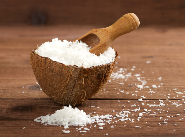 grated coconut on wooden background - Foto, afbeelding