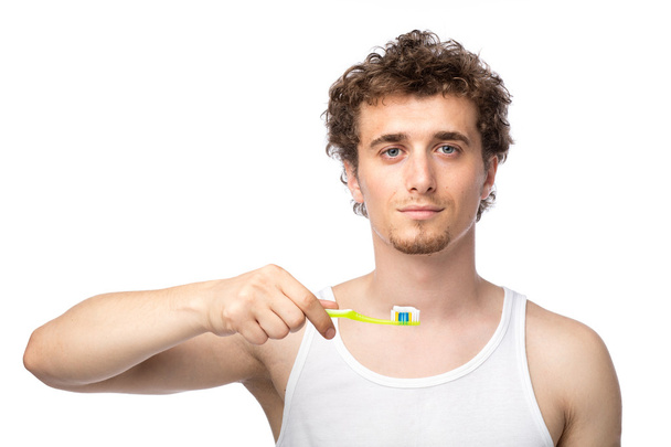 curly guy brushing his teeth - Fotografie, Obrázek