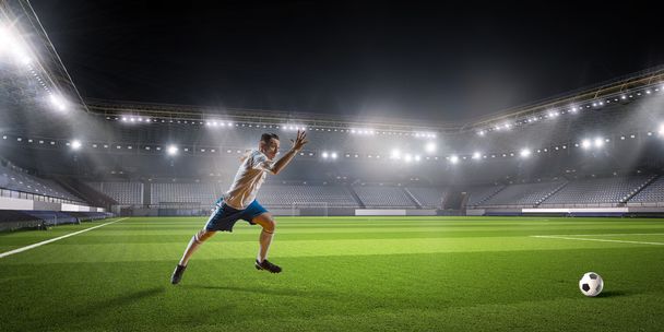 Soccer player hitting ball   . Mixed media - Foto, Imagen
