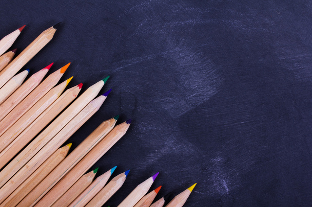 Coloured pencils on a worn black background - Φωτογραφία, εικόνα