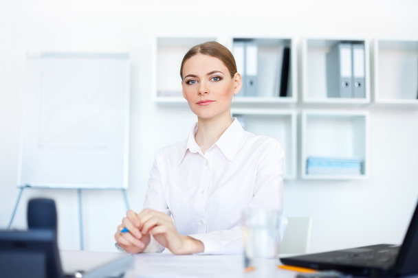 Portrait of beautiful young business woman sitting at desk in br - Φωτογραφία, εικόνα