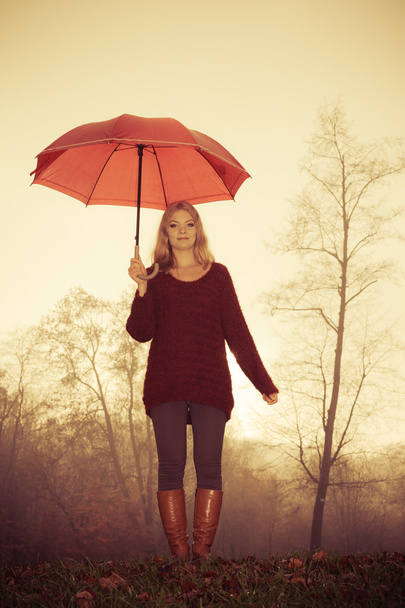 Fashion woman with umbrella relaxing in fall park. - Foto, Imagen