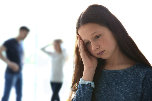 Family problems concept. Sad girl and abusing parents - Foto, afbeelding