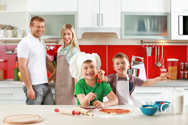 Happy family making pizza  - Foto, afbeelding