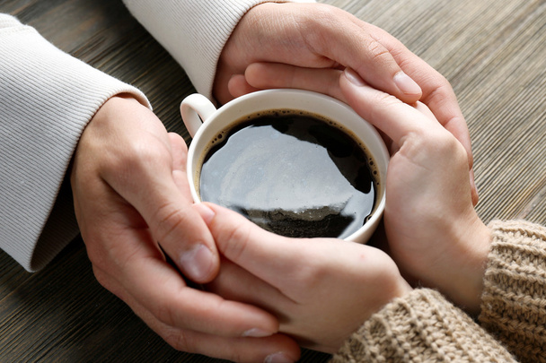 Lovely couple holding cup of coffee - Φωτογραφία, εικόνα