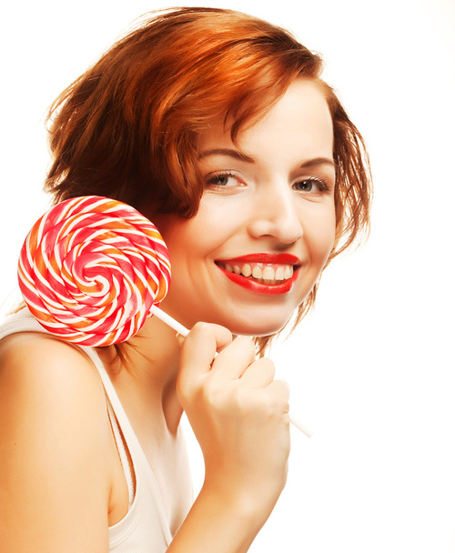 Pretty young woman holding lolly pop. - Zdjęcie, obraz