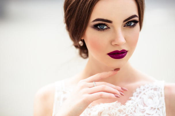 gorgeous bride with fashion makeup and hairstyle in a luxury wedding dress - Foto, afbeelding