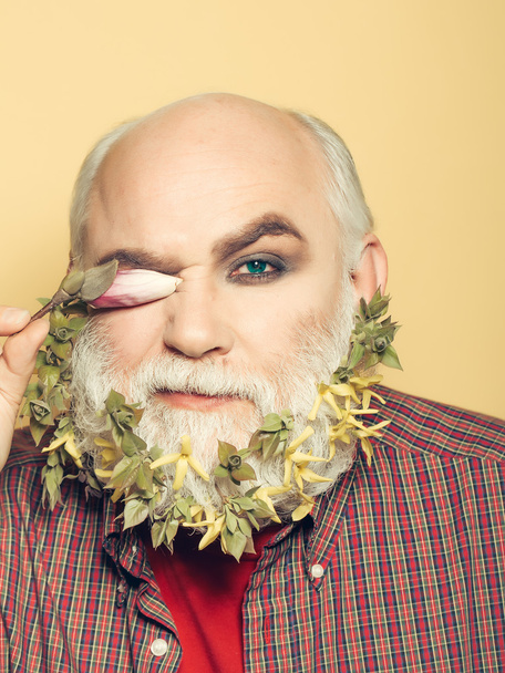 old man with flowers and leaves in beard - Photo, Image