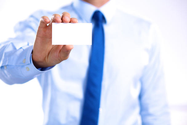 young businessman holds out his hand with a business card - Foto, Imagem