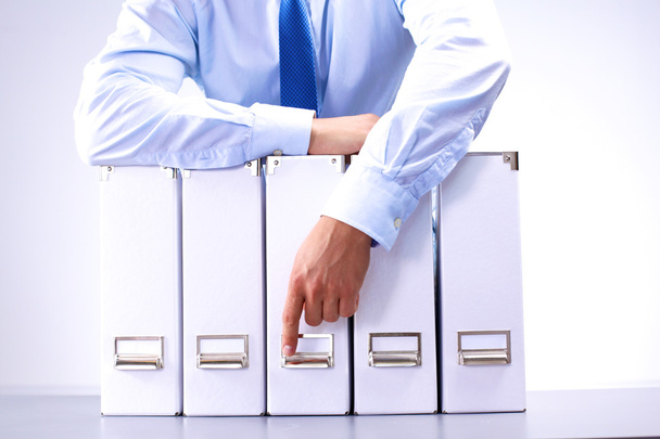 businessman standing over a folder with documents - Photo, Image