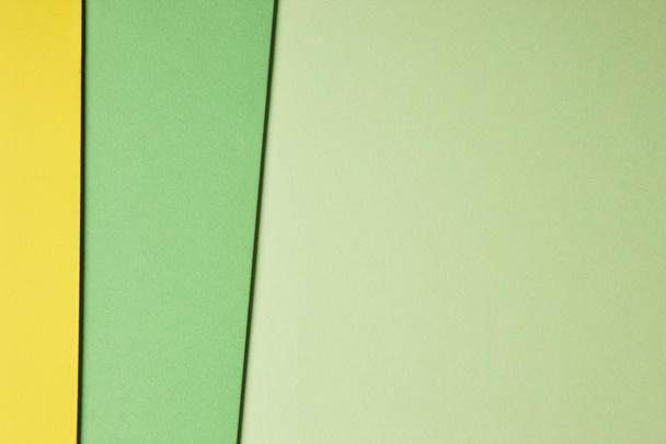 Colored cardboards background in green yellow tone. Copy space - Фото, зображення