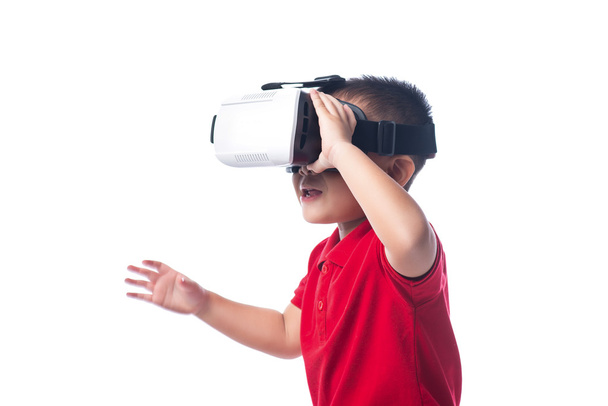 Amazed little asian boy looking in a VR goggles  - 写真・画像
