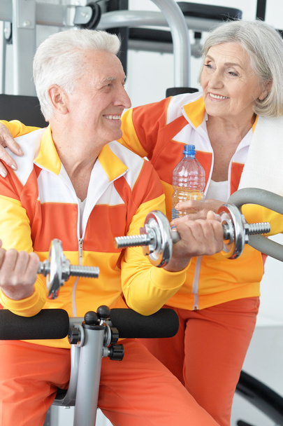 senior couple exercising in gym - Фото, зображення