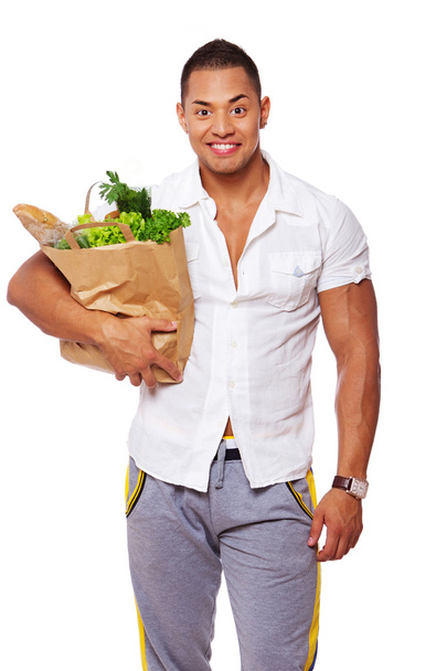 Retrato de homem bonito posando no fundo branco com comida
 - Foto, Imagem