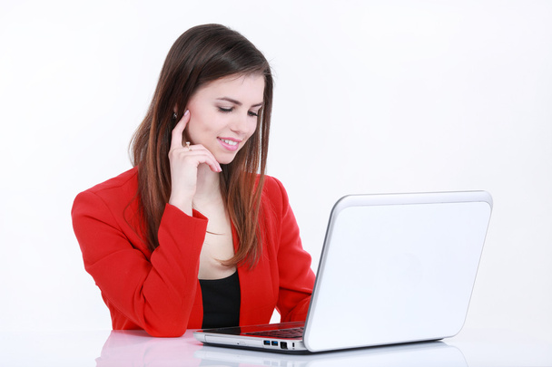 Business smiling woman working on laptop at office - Photo, image