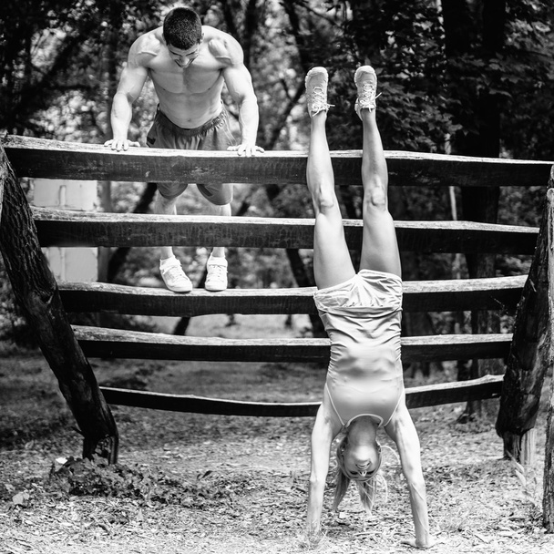Crossfit couple exercising in park - Photo, Image
