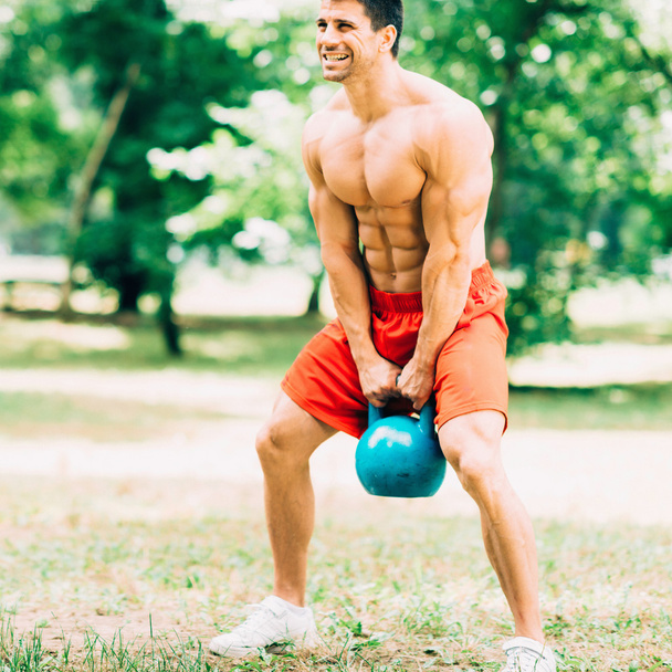 crossfit athlete exercising with kettle bell - Photo, Image