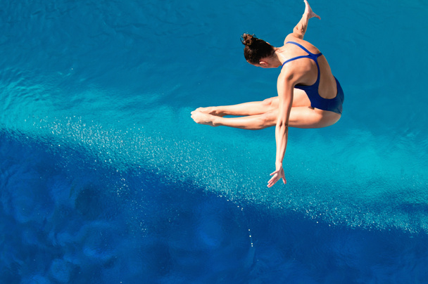 水面上の空気中の女性ダイバー - 写真・画像
