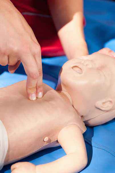 Woman doing infant chest compressions - Photo, Image