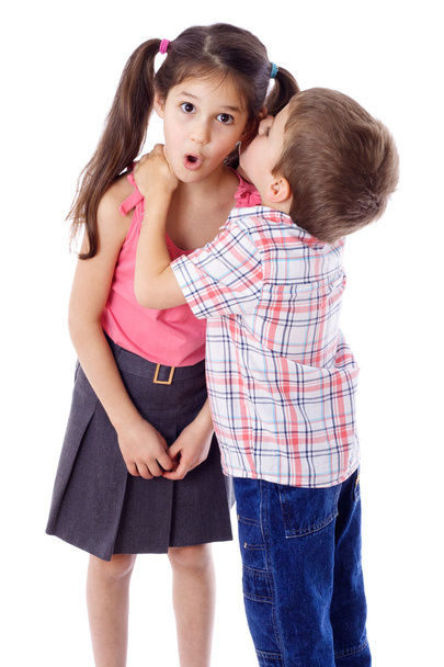 Little boy whispering something to girl - 写真・画像