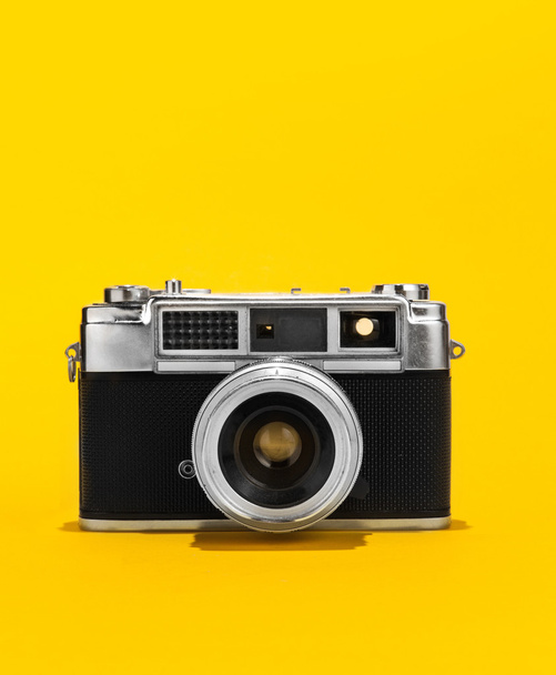 Retro analog film camera on yellow background - Photo, Image