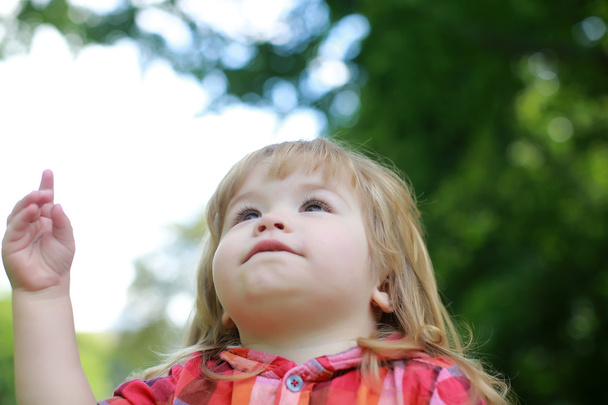 niño pequeño feliz sobre fondo verde natural
 - Foto, Imagen