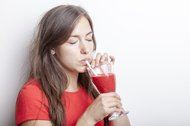 woman has a raspberry smoothie drink - Φωτογραφία, εικόνα