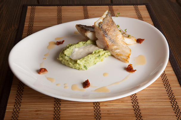 pikeperch with mashed potatoes and cheese sauce on white plate - Photo, Image