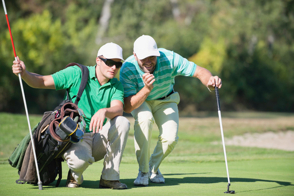 male Golfers and Caddy  - 写真・画像