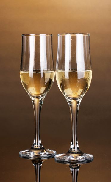 Glasses of champagne on brown background - Fotoğraf, Görsel