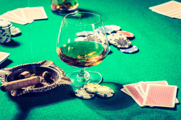 Vintage gambling table with whiskey, cigar and cards - Фото, изображение