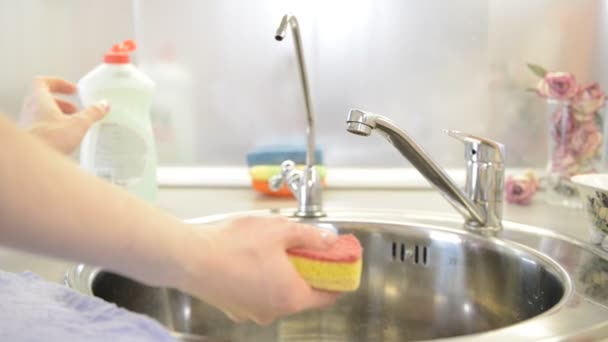 washing dishes in the sink use detergents - Footage, Video