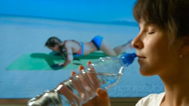 Woman drinking water - Filmati, video