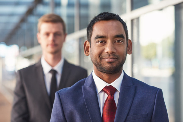 businessman standing with colleague in background - Foto, imagen