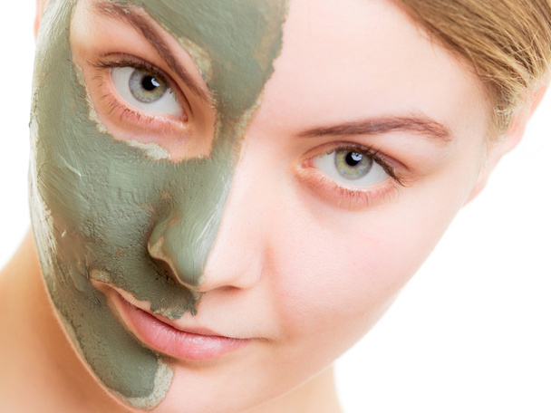 Woman in clay mud mask on face isolated on white. - Фото, изображение