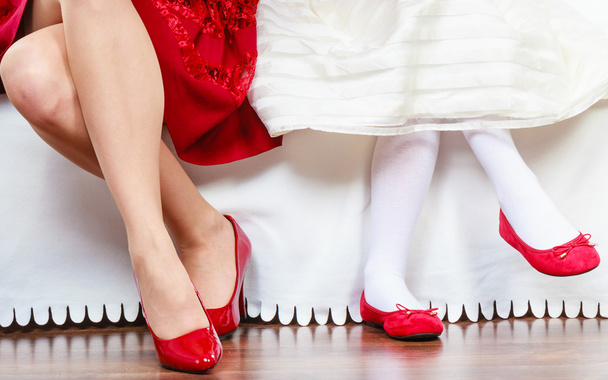 Legs mother and daughter in red shoes - Foto, Bild