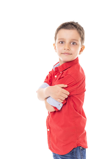 Portrait of a cute modern boy with arms folded over white  background - 写真・画像