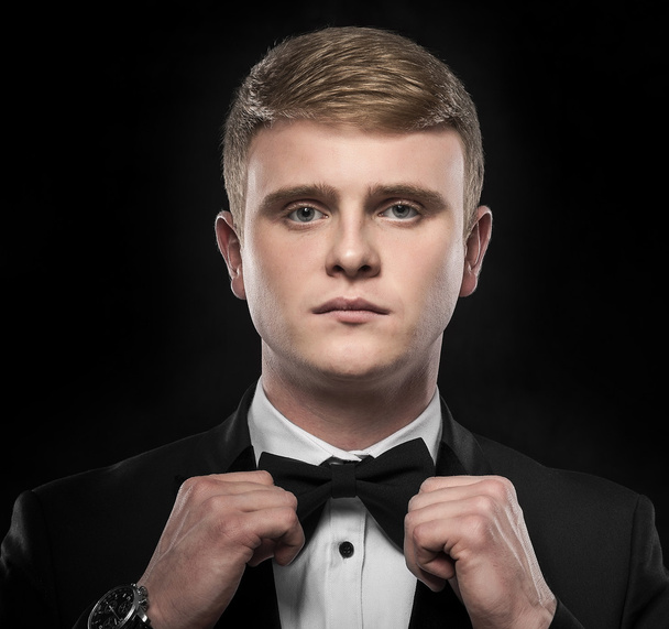 Young handsome man in black suit. - Valokuva, kuva